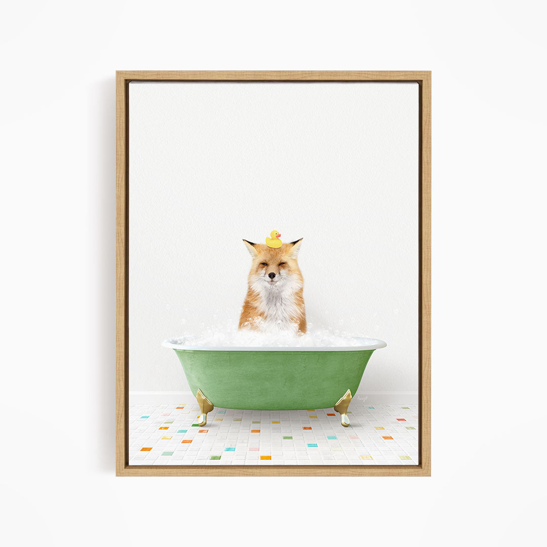 A fox is sitting in a green bathtub filled with bubbles, with a rubber duck perched on its head.