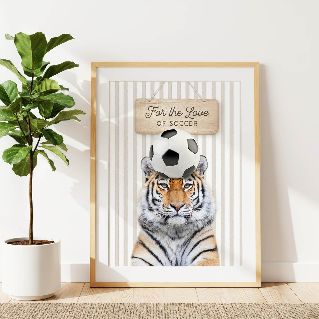 A framed poster featuring a tiger with a soccer ball on its head, accompanied by the text "For the Love of Soccer".