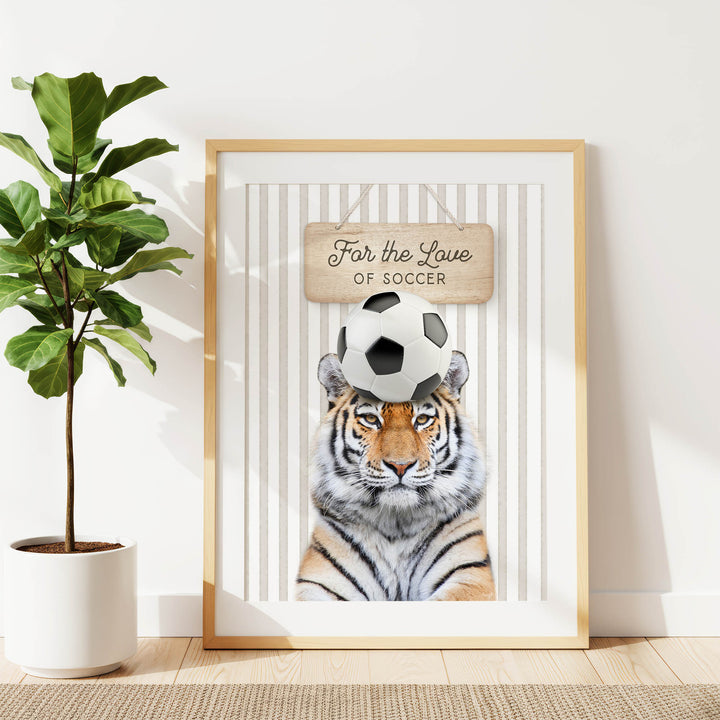 A framed poster featuring a tiger with a soccer ball on its head, accompanied by the text "For the Love of Soccer".