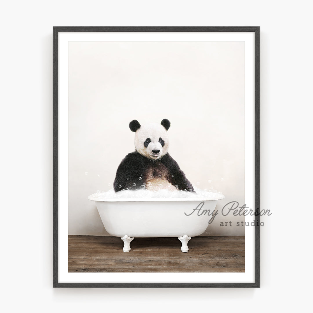 a panda bear sitting in a bath tub