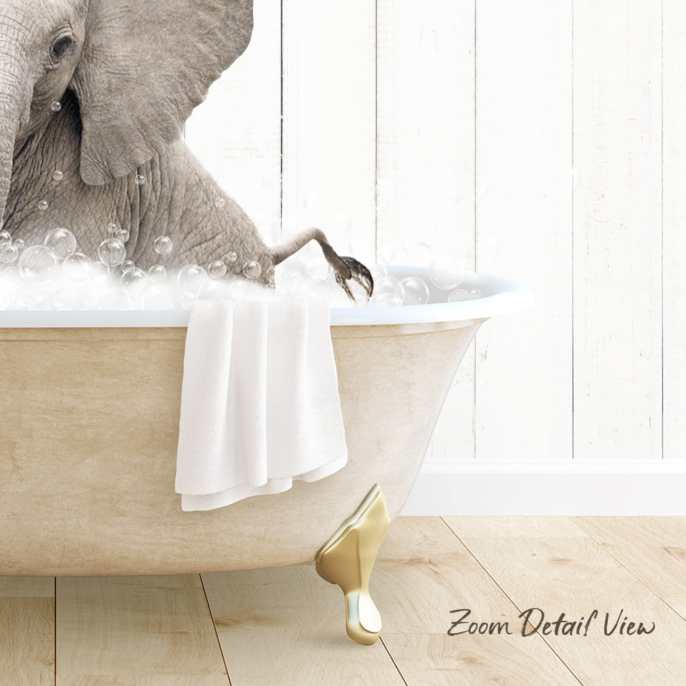 A large elephant is sitting in a bathtub filled with bubbles, with a towel draped over the side of the tub.