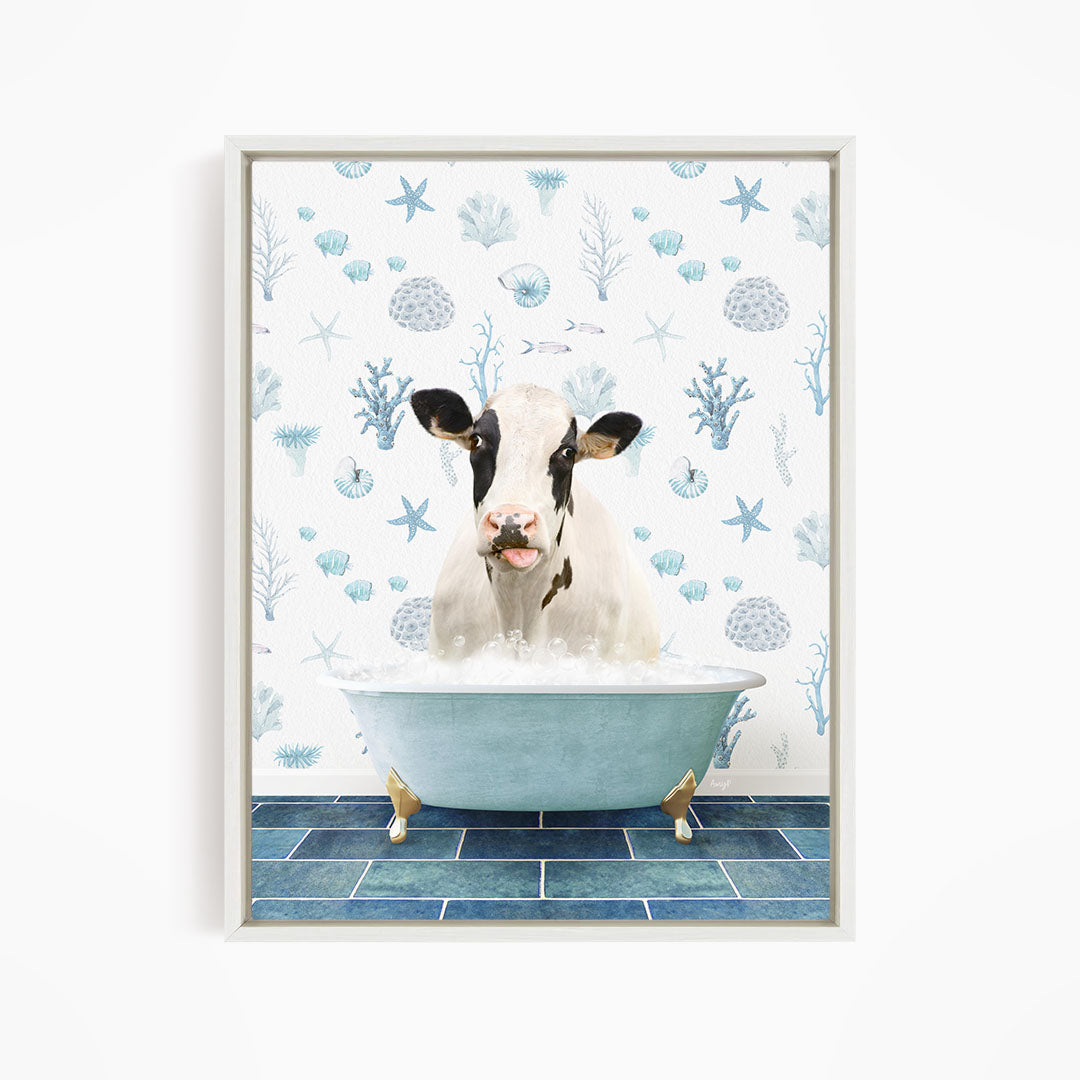 A cow is sitting in a bathtub filled with bubbles, surrounded by a blue and white ocean-themed wallpaper.