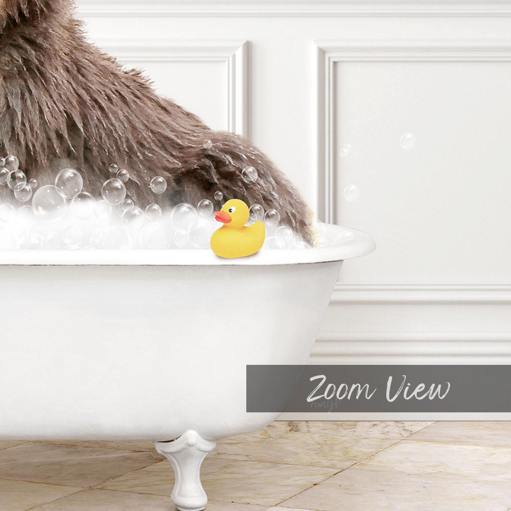 A fluffy brown dog is sitting in a white bathtub filled with bubbles, with a yellow rubber duck floating on the water.