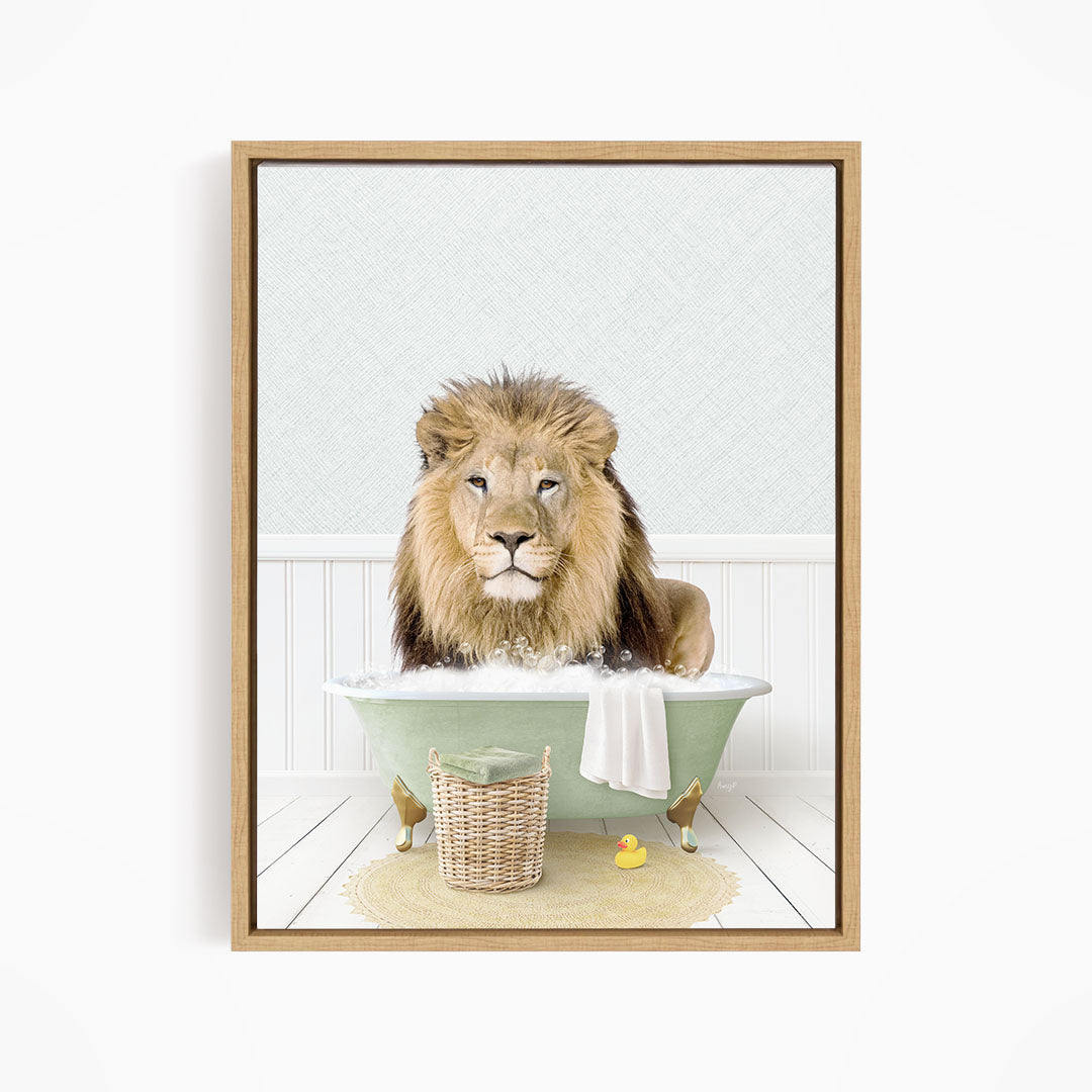 A lion sitting in a green bathtub filled with water, surrounded by a basket of toys and a yellow rubber ducky.