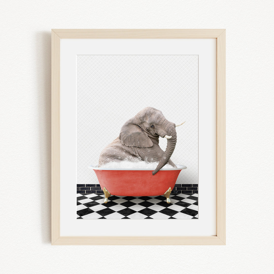 A gray elephant is sitting in a red bathtub filled with water, surrounded by a black and white checkered floor.