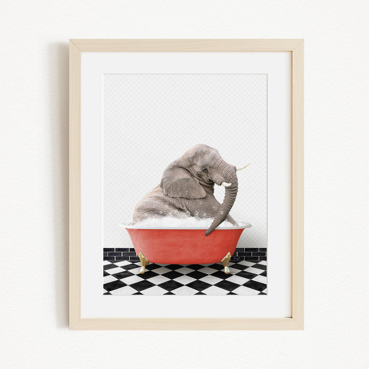 A gray elephant is sitting in a red bathtub filled with water, surrounded by a black and white checkered floor.