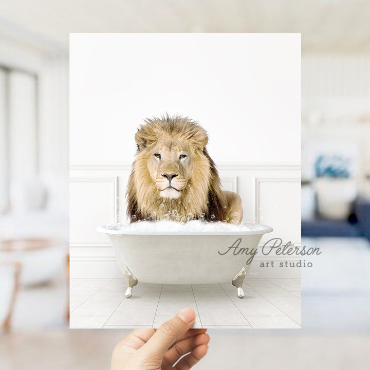 a hand holding a card with a lion in a bathtub