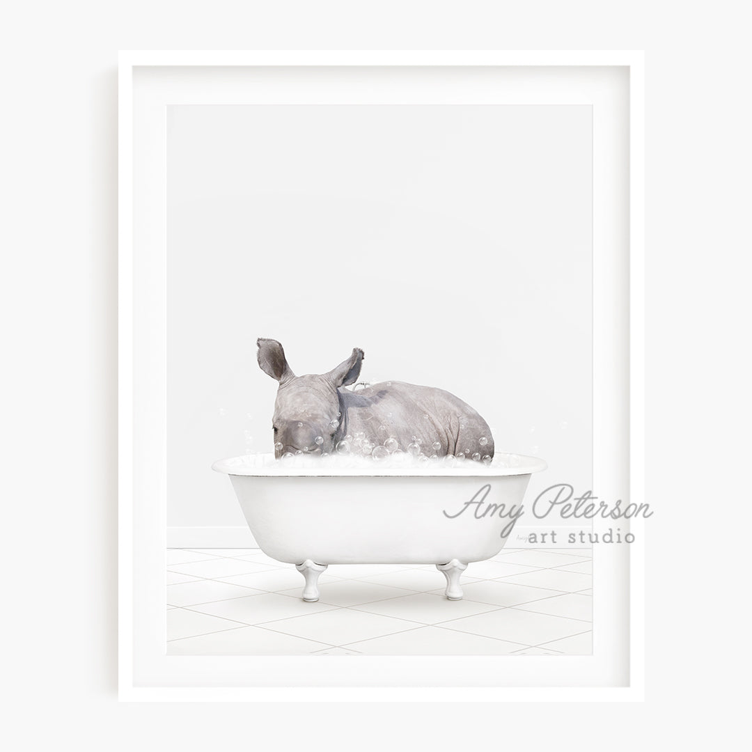 a rhino laying in a bathtub with a white background