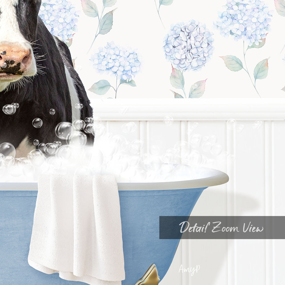 A black and white cow is sitting in a blue bathtub filled with bubbles, with a floral patterned wall behind it.