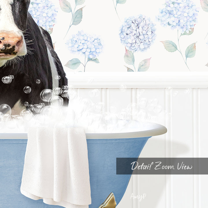 A black and white cow is sitting in a blue bathtub filled with bubbles, with a floral patterned wall behind it.