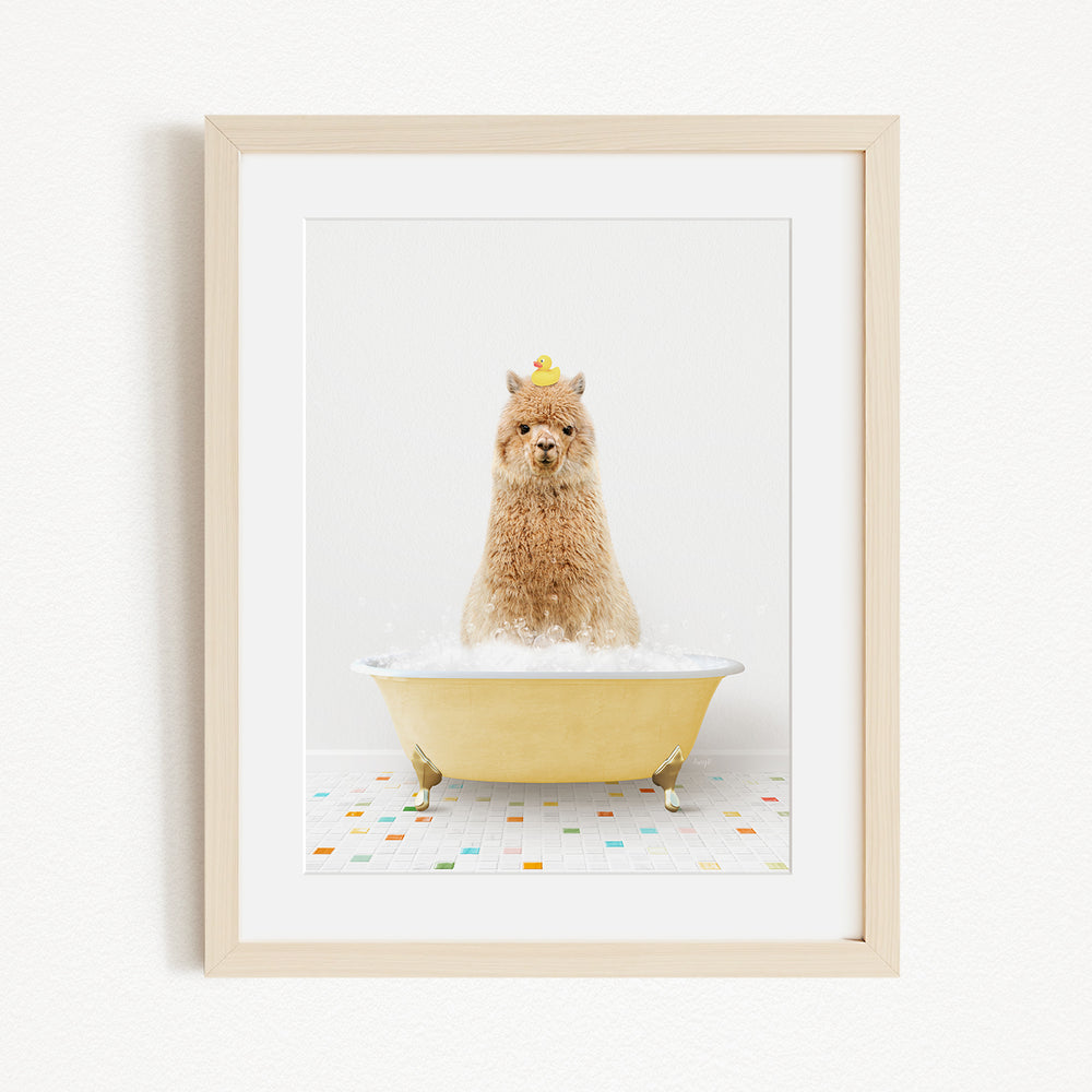 A fluffy alpaca sits in a yellow bathtub filled with bubbles, wearing a yellow crown and surrounded by colorful tiles on the floor.