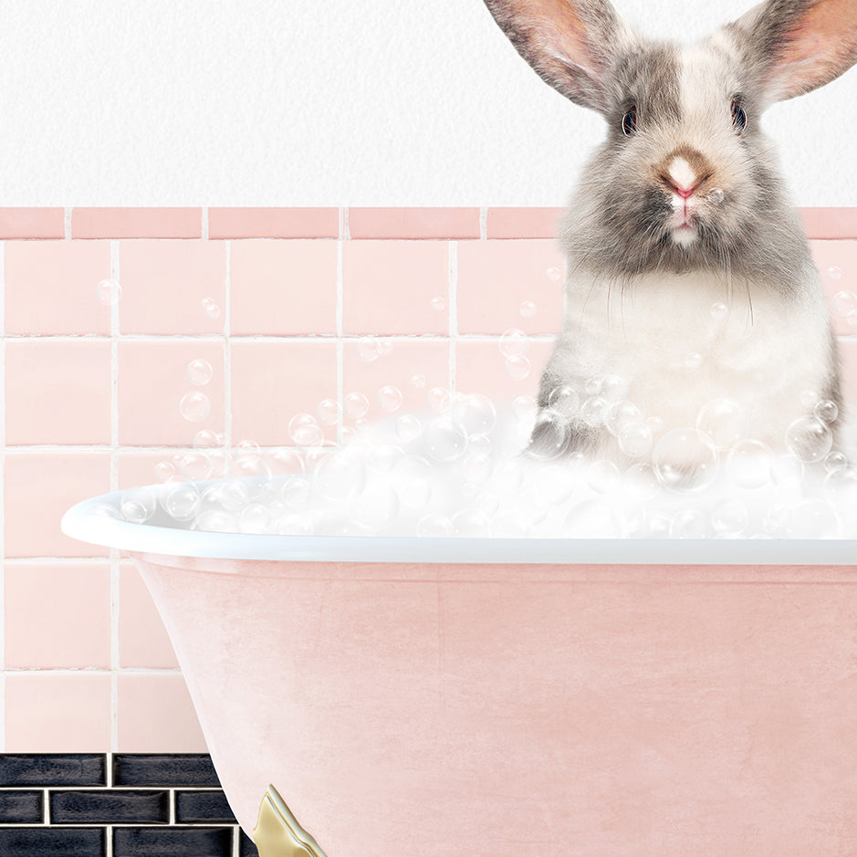 a rabbit sitting inside of a bath tub filled with bubbles