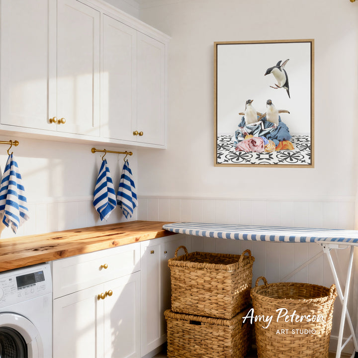 a well-organized and clean laundry room with white cabinets, a wooden countertop, and a framed artwork featuring three birds on a patterned surface.