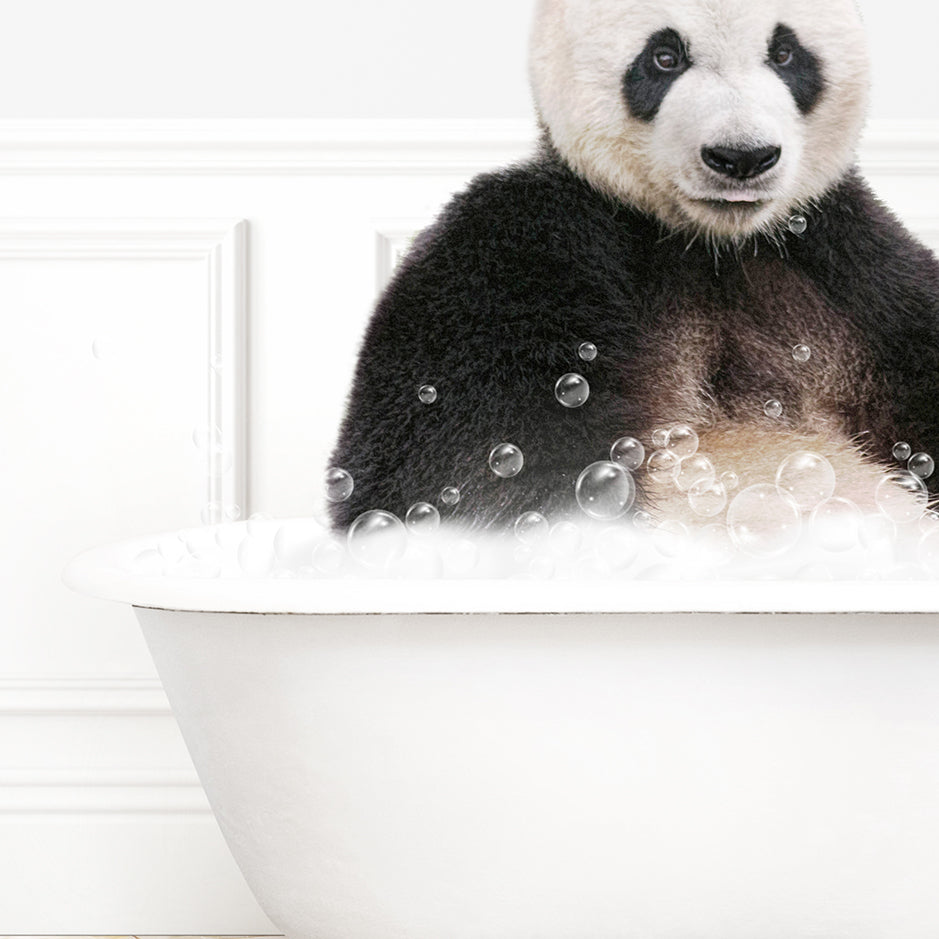 a panda bear sitting in a bathtub full of bubbles