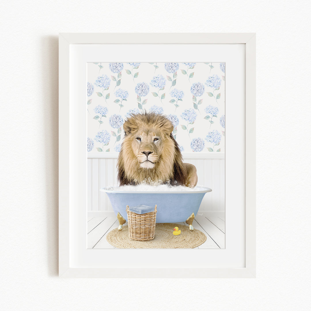 A lion is sitting in a blue bathtub filled with water, surrounded by yellow rubber ducks.