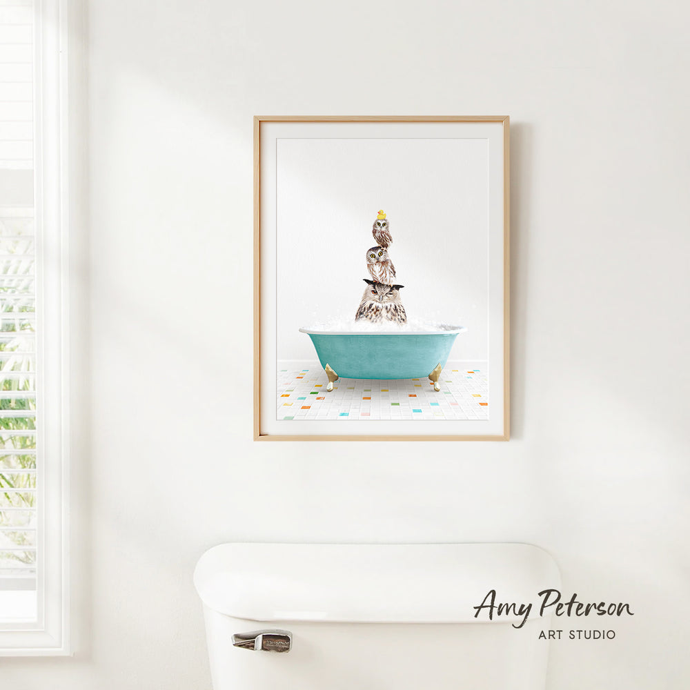 A framed image of a person sitting in a bathtub filled with bubbles, with a bird perched on the edge of the tub.