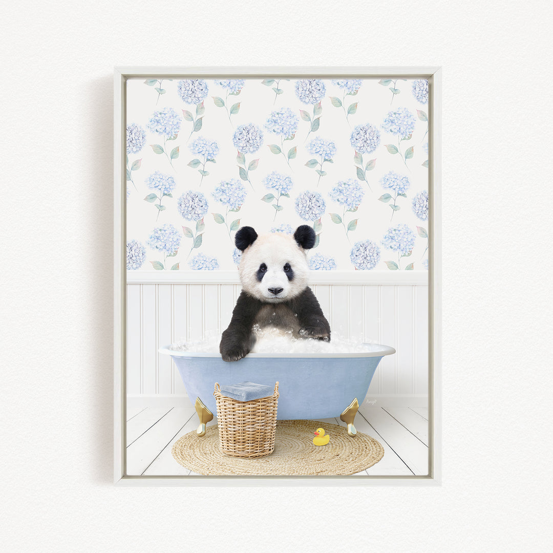 A panda bear sitting in a blue bathtub, surrounded by a wicker basket and rubber duckies, with a floral patterned wall behind it.