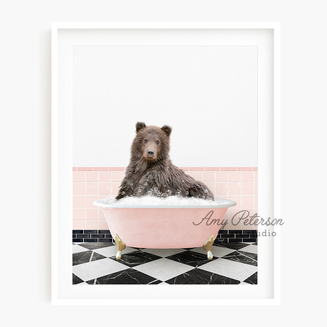 a brown bear sitting in a pink bath tub