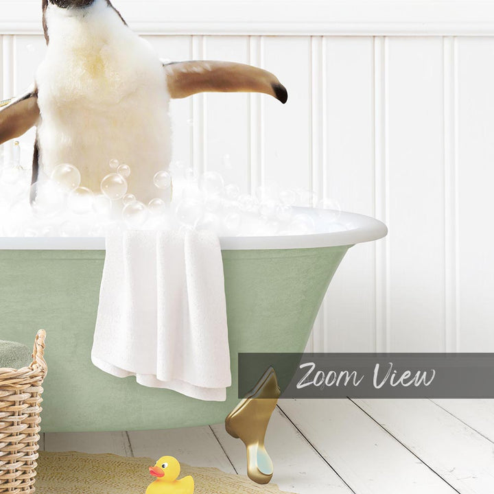 A penguin standing in a bathtub filled with bubbles, with a towel and rubber duck nearby.