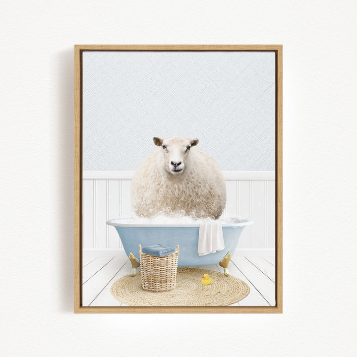 A fluffy white sheep sits in a blue bathtub filled with bubbles, surrounded by a basket of bath toys and a yellow rubber duck.