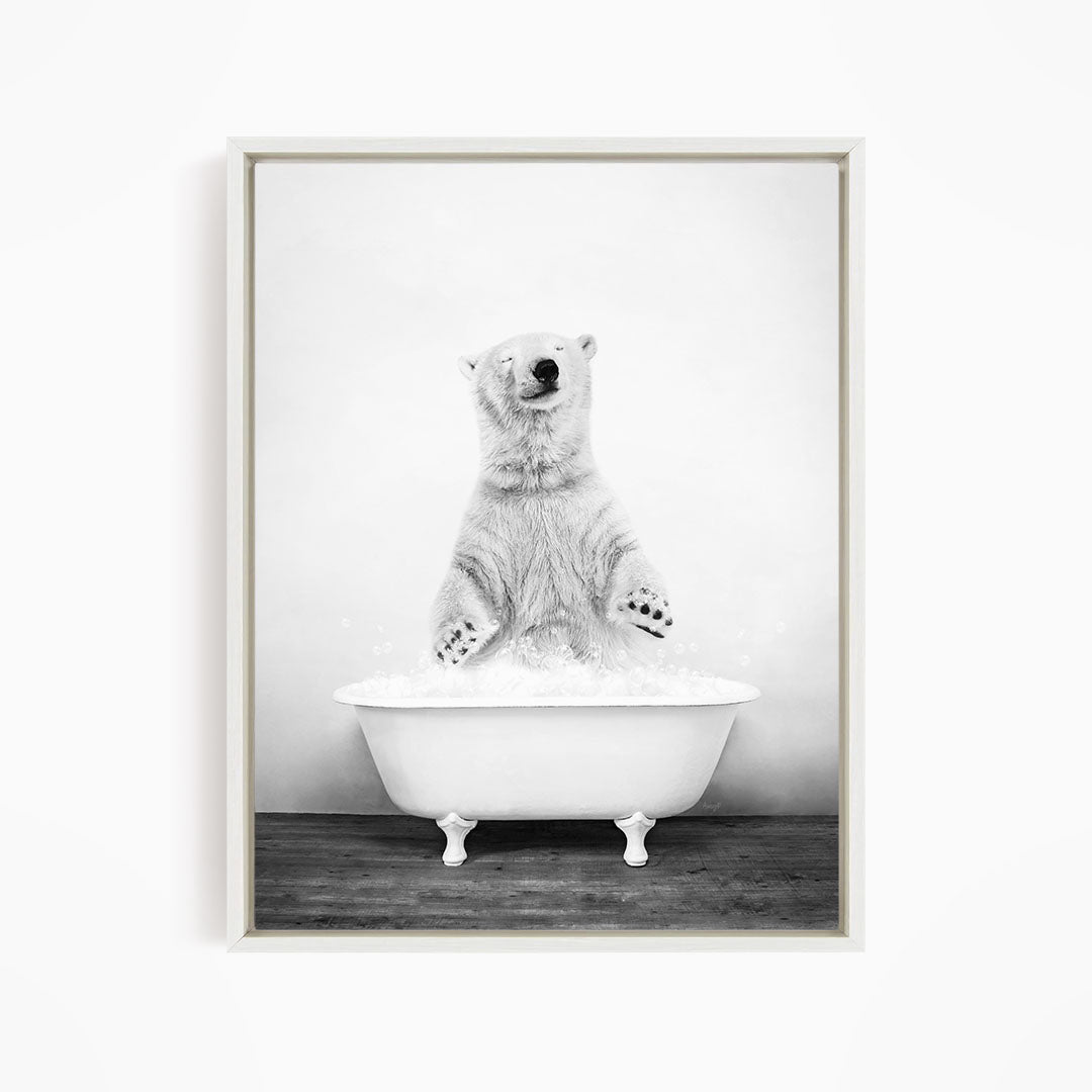 A polar bear standing in a white bathtub filled with water, appearing to be enjoying a bath.