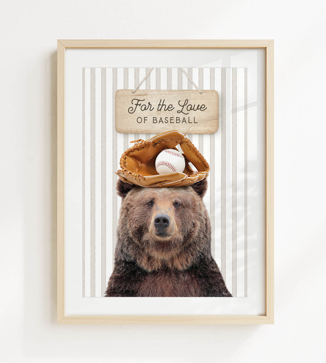 A framed image of a brown bear wearing a baseball glove and holding a baseball, with a sign above that says "For the Love of Baseball".