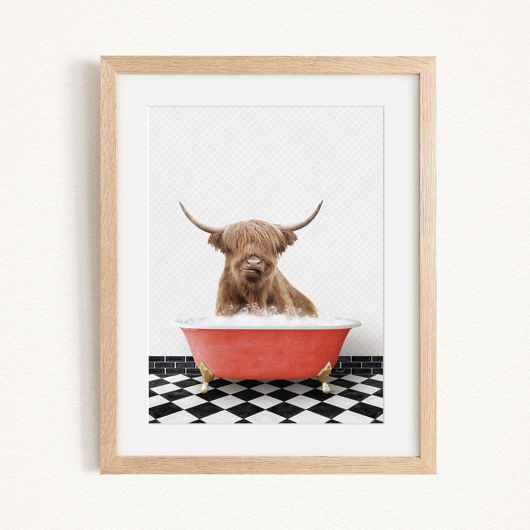 A brown Highland cow with large horns is sitting in a red bathtub on a black and white checkered floor.