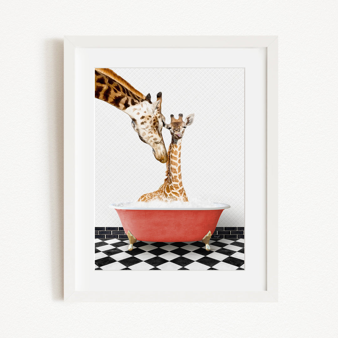 A mother giraffe and her baby giraffe are sitting together in a red bathtub, with the mother gently licking her baby.