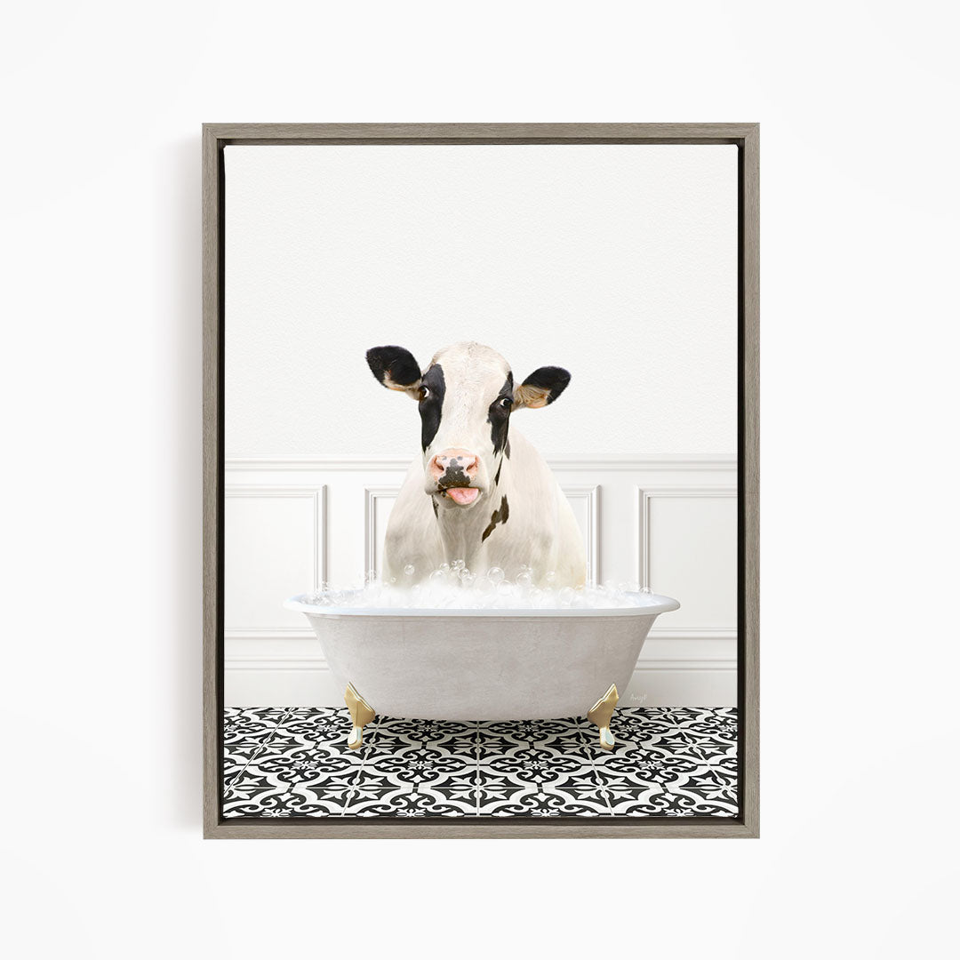 A black and white cow is sitting in a white bathtub filled with water, creating a whimsical and humorous scene.
