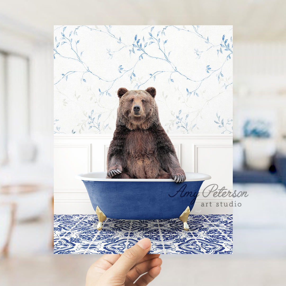 a person holding up a card with a bear in a bathtub