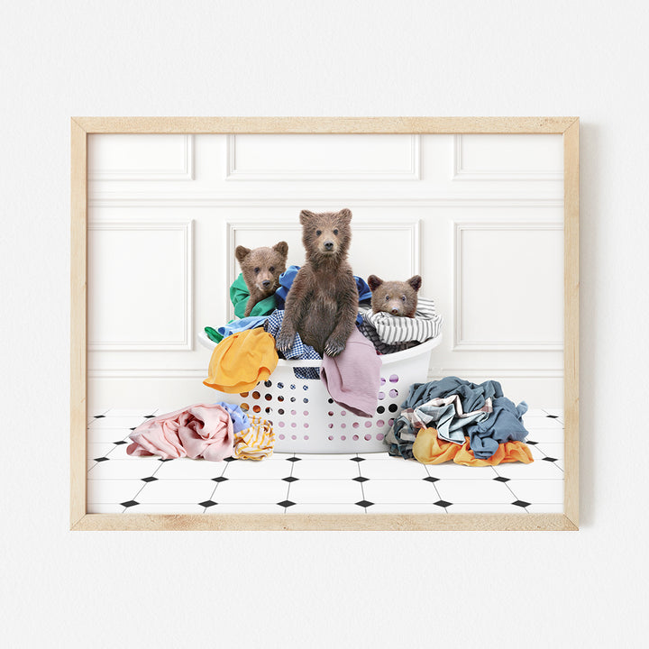 a group of teddy bears sitting in a laundry basket