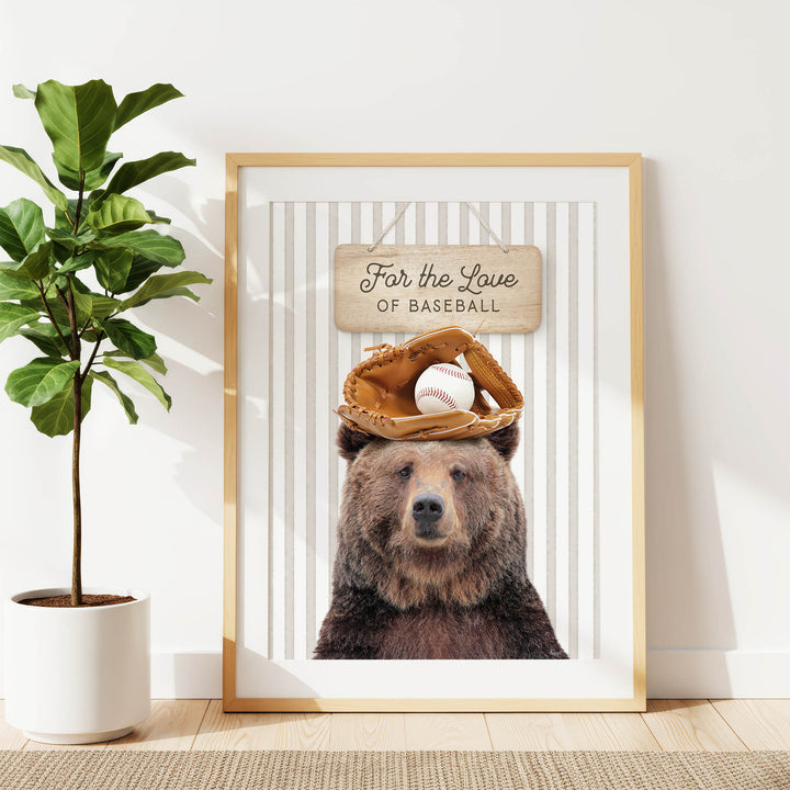 A framed print of a brown bear wearing a baseball glove and ball, with a sign above that says "For the Love of Baseball".