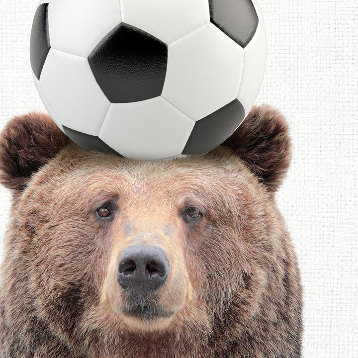 a bear balancing a soccer ball on its head