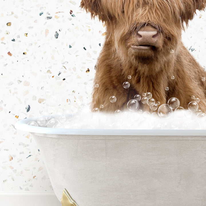 a brown dog sitting in a bathtub filled with bubbles