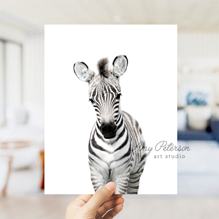 a person holding up a card with a picture of a zebra