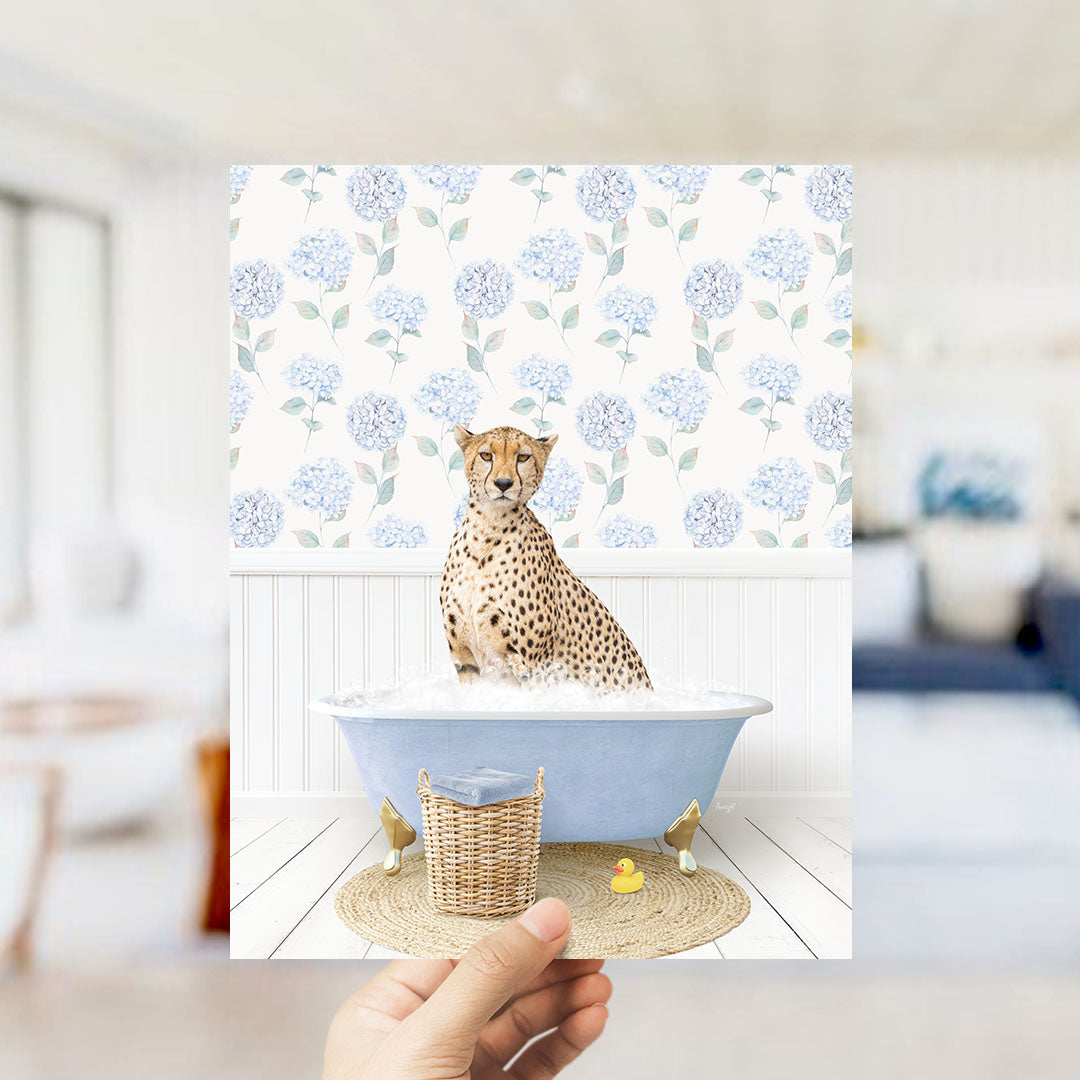 A cheetah sitting in a blue bathtub filled with water, surrounded by a wicker basket and a rubber duck.