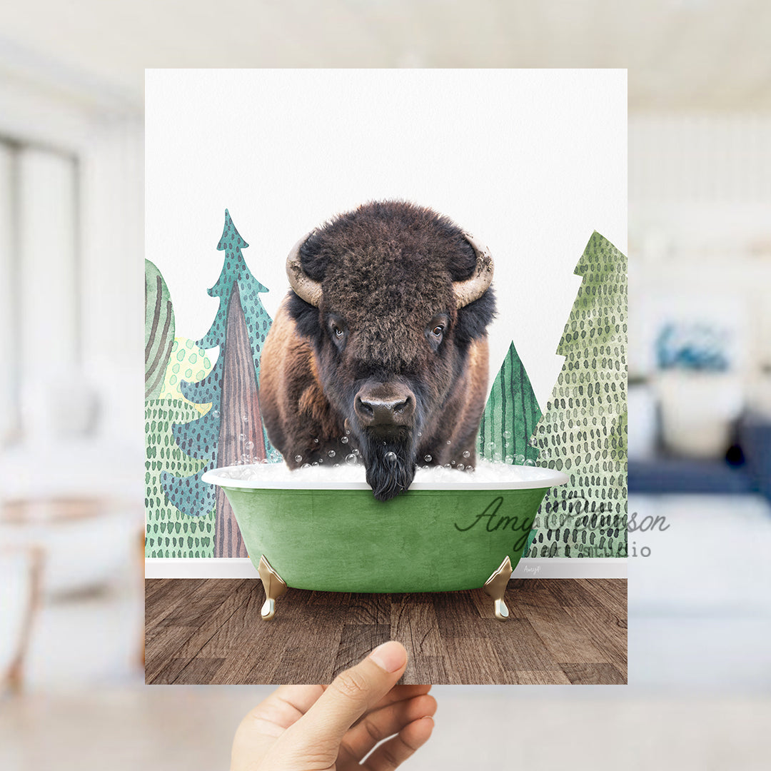 a person holding up a picture of a bison in a bathtub