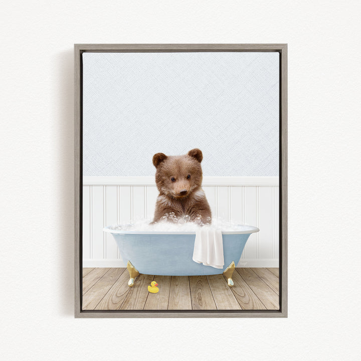 A brown bear sitting in a blue bathtub filled with water, surrounded by rubber ducks.