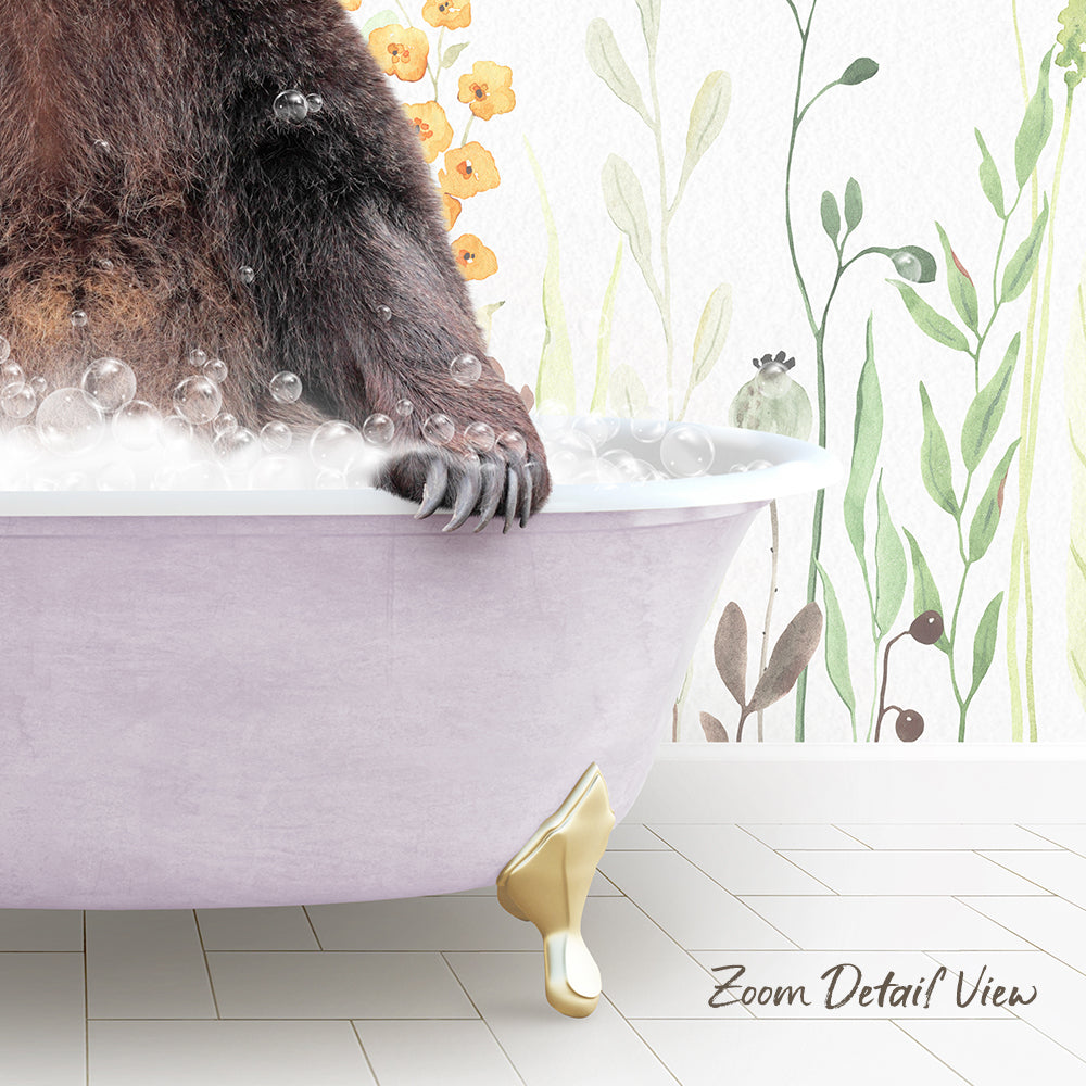 A close-up of a bear's paw resting on a pink bathtub filled with bubbles, with a floral wallpaper in the background.