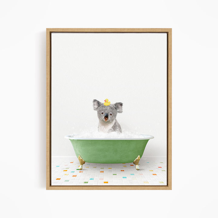 A koala bear sitting in a green bathtub filled with bubbles, wearing a yellow rubber duck hat.