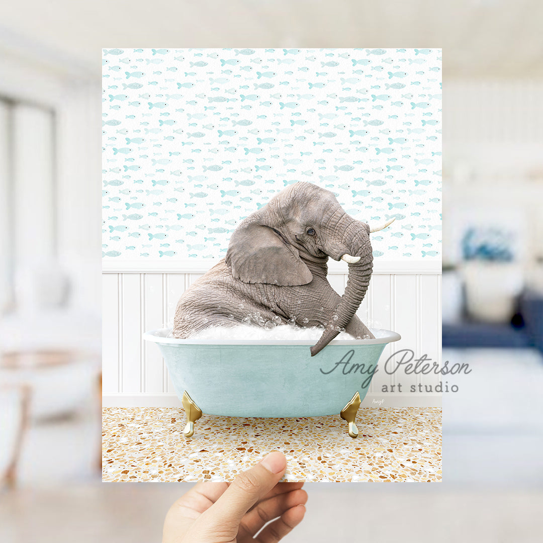 a person holding up a picture of an elephant in a bathtub