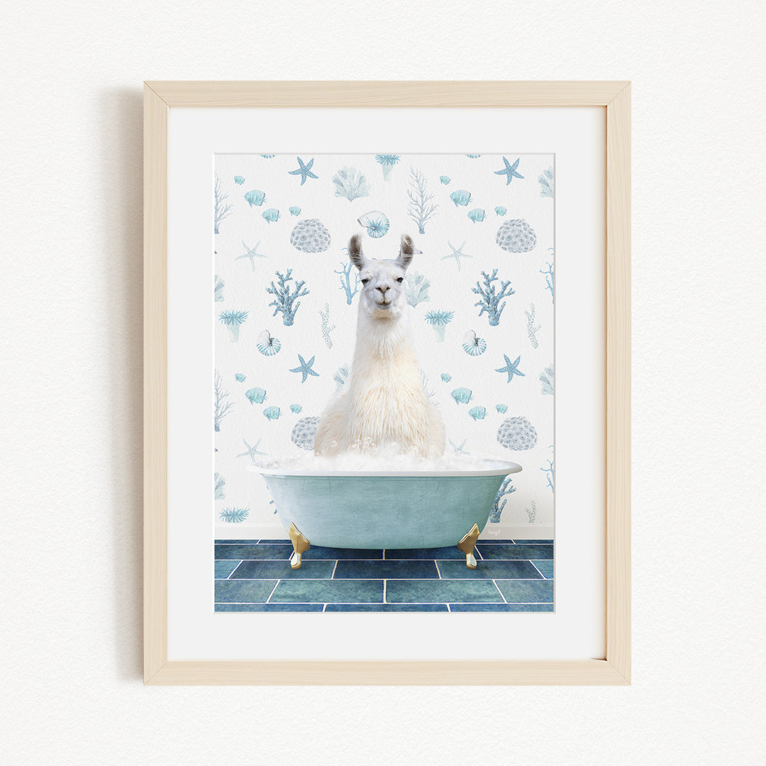 A white llama sitting in a blue bathtub filled with bubbles, surrounded by a pattern of blue and white seashells and starfish.