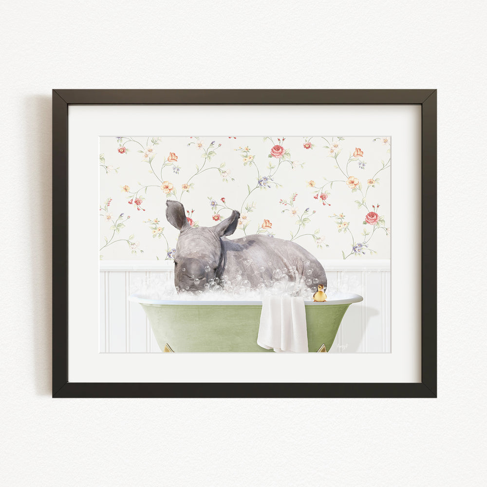 A rhinoceros is sitting in a green bathtub filled with water, surrounded by a floral patterned wall.
