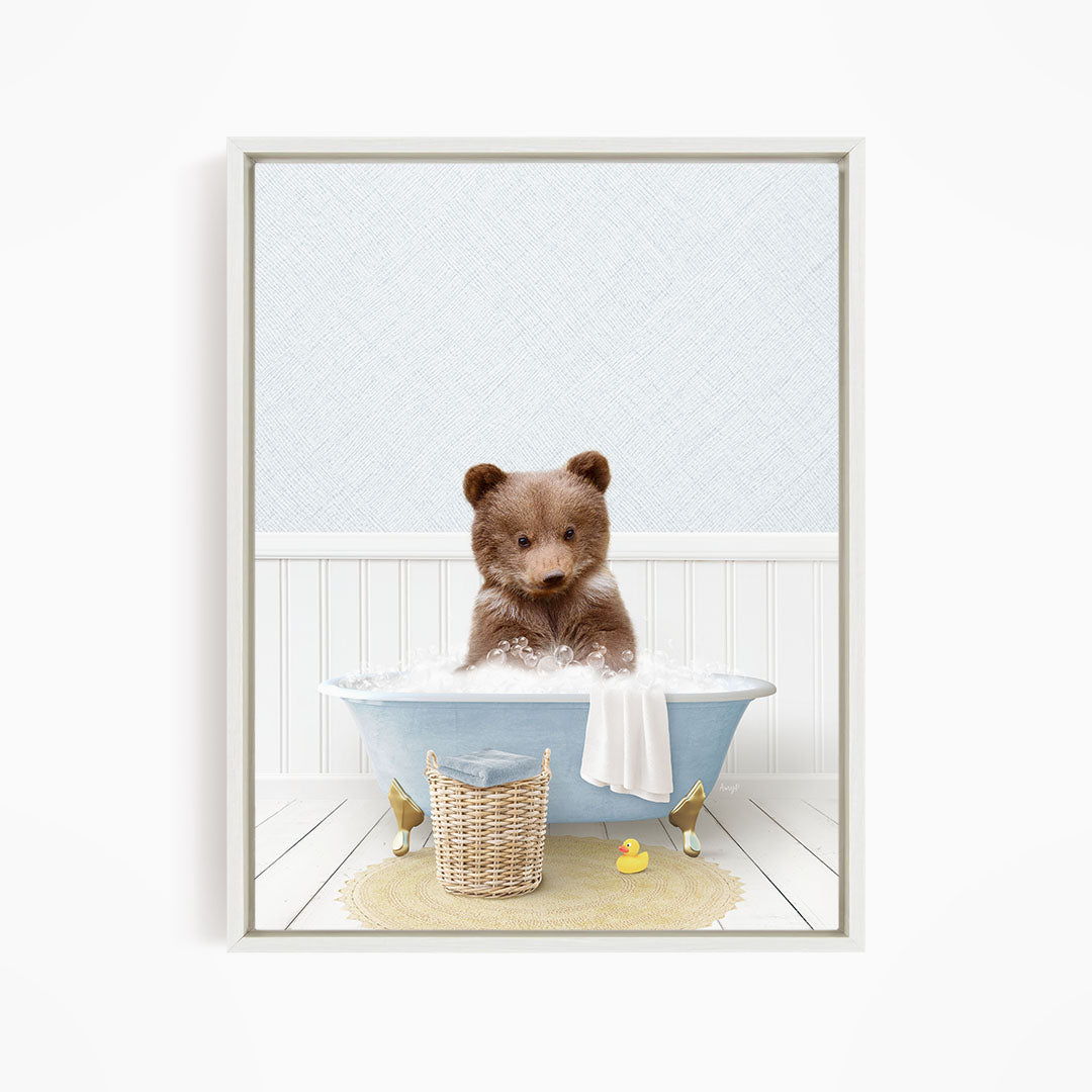 A brown bear sitting in a blue bathtub filled with water, surrounded by a yellow rubber duck and a basket.