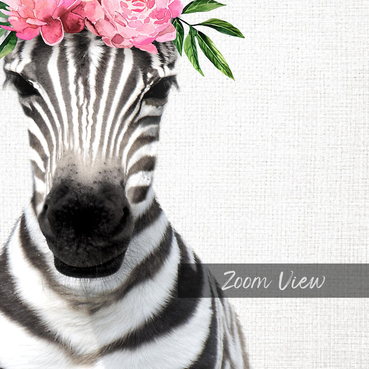 A close-up of a zebra's face with a pink flower crown on its head, against a plain white background.