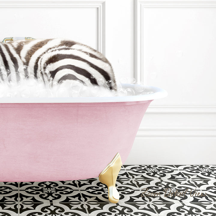A zebra lying in a pink bathtub filled with bubbles, surrounded by a black and white patterned floor.