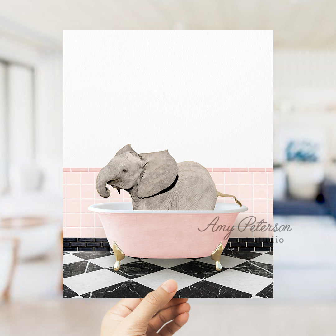 a person holding up a card with an elephant in a bathtub