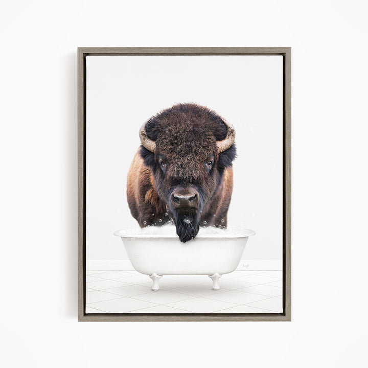 A buffalo with a long beard is standing in a white bathtub, looking directly at the camera.