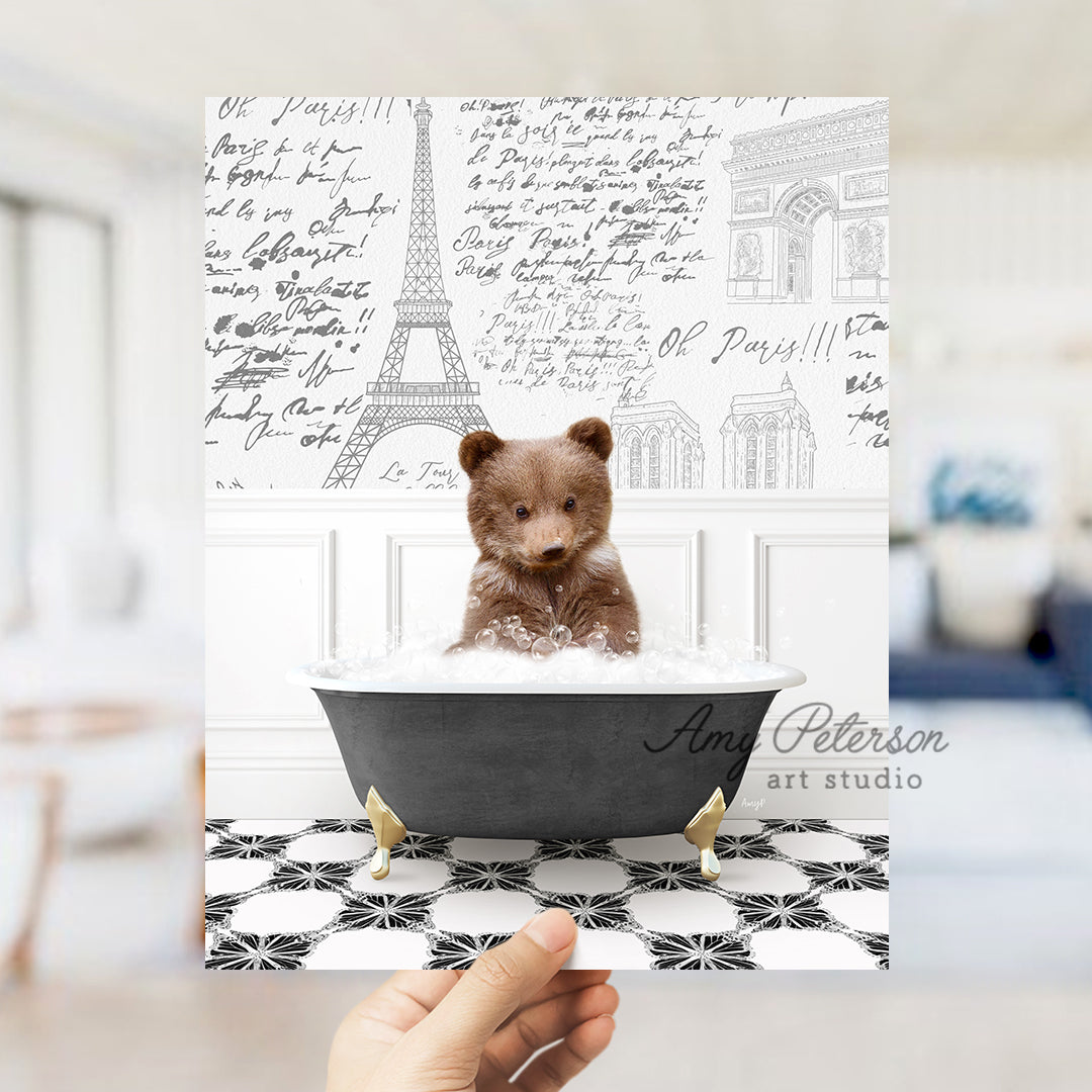 a person holding a card with a picture of a teddy bear in a bathtub