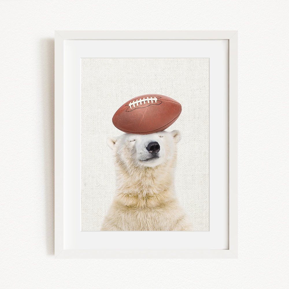 A polar bear is sitting on its head, balancing a football on its head, with its eyes closed.